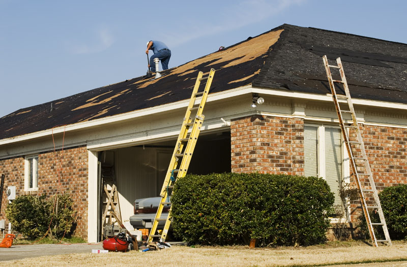 Roofer replacing an old roof